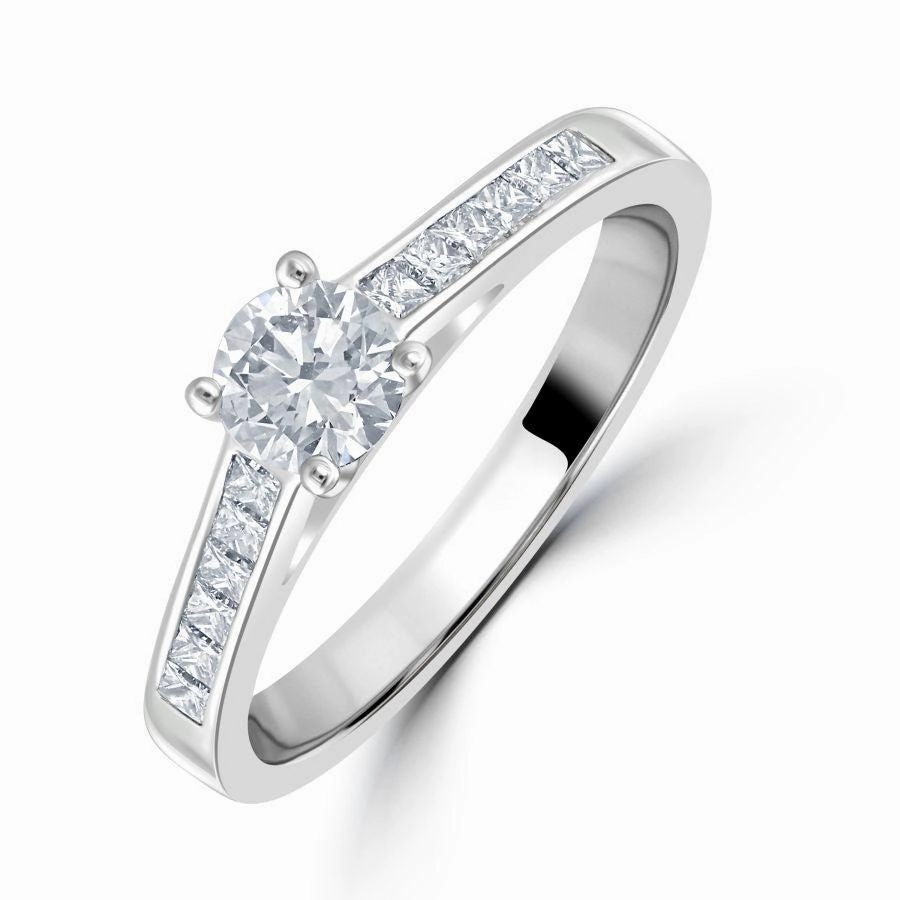 0.66ct Round Brilliant Cut Diamond Solitaire Platinum Ring with Diamond Shoulders texture-diamond  