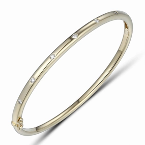 18ct Gold yellow gold 7 inset spaced out across the top diamond set bangle texture-diamond  