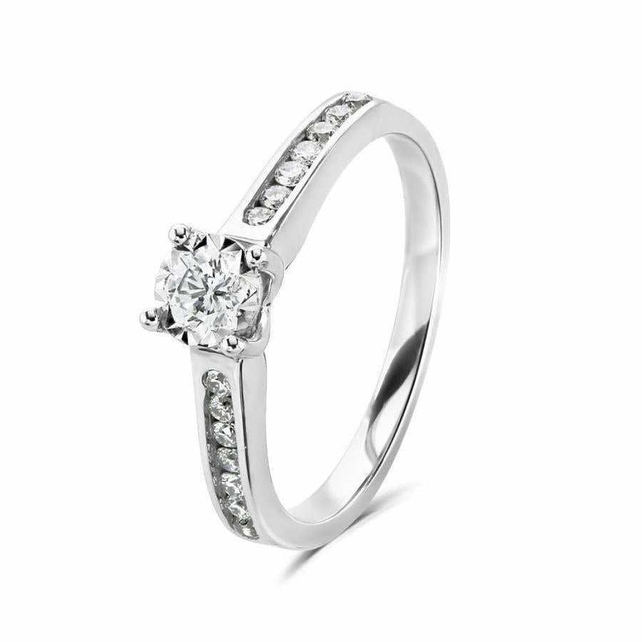 18ct Gold yellow gold illusion set round brilliant cut solitaire Diamond ring with Diamond shoulders texture-diamond  