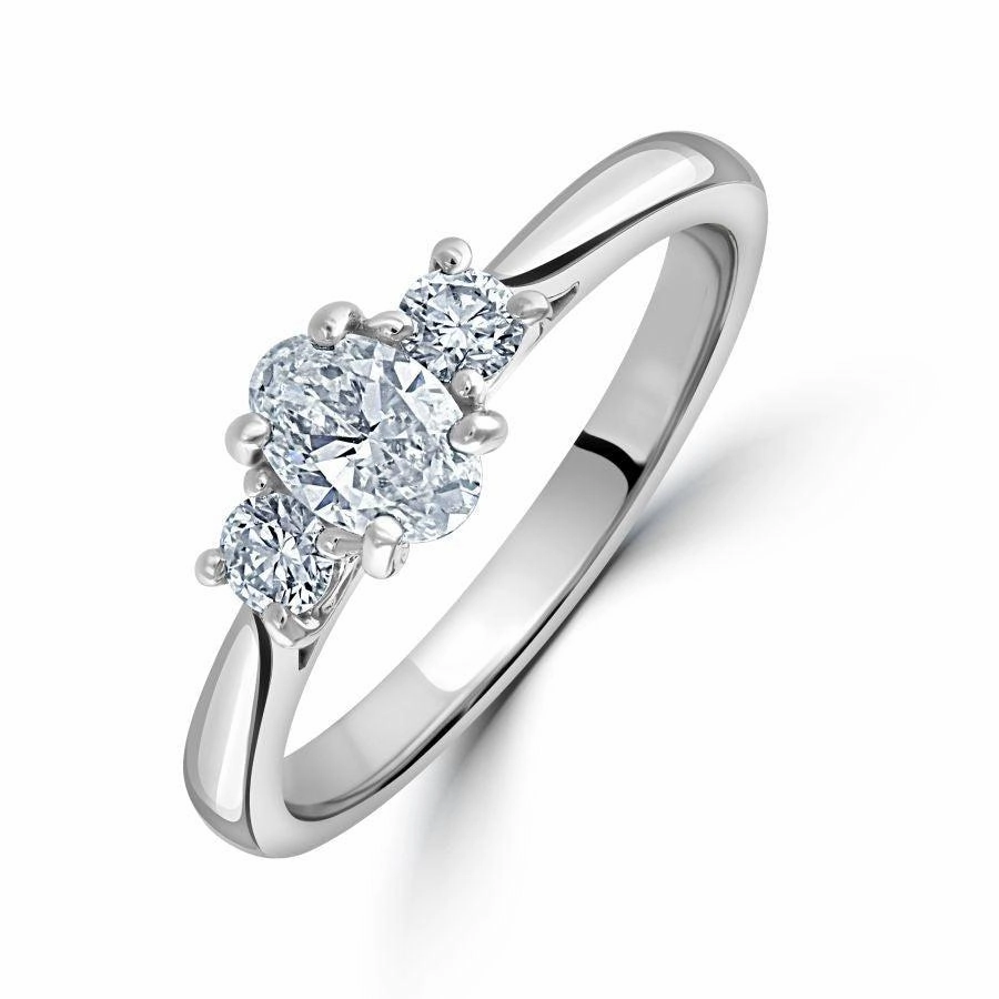Platinum Oval & Round Brilliant Cut Diamond Trilogy Ring texture-diamond  