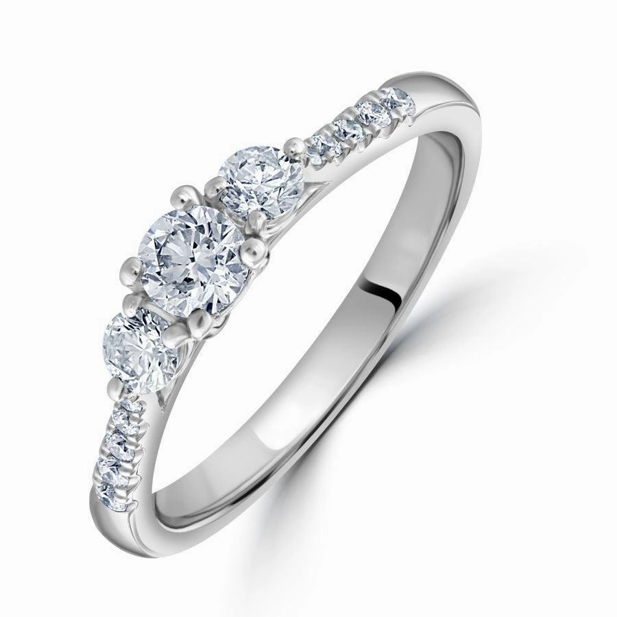 Platinum Round Brilliant Cut Diamond Trilogy Ring with Diamond Shoulders texture-diamond  