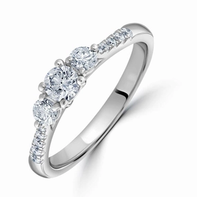 Platinum Round Brilliant Cut Diamond Trilogy Ring with Diamond Shoulders texture-diamond  
