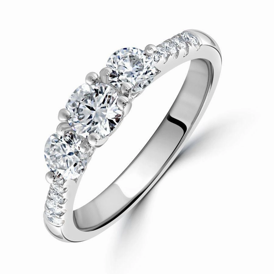 Platinum Round Brilliant Cut Diamond Trilogy Ring with Diamond Shoulders texture-diamond  